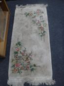 A fringed Chinese hearth rug