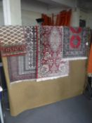 A fringed carpet and four fringed Persian design rugs