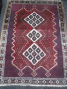 An Afshar rug, South West Iran, the three stepped ivory medallions upon a red field,