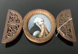 A portrait miniature of a pretty girl painted on porcelain with wooden picture frame fretwork and