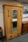 An Edwardian satin walnut mirrored wardrobe,