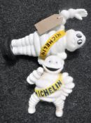 Two cast metal Michelin men money boxes