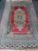 A Caucasian design rug on salmon ground,