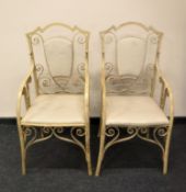 A pair of wrought iron shield back garden armchairs
