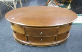 An oval entertainment stand fitted two drawers in a walnut finish