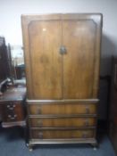 A walnut wardrobe fitted three drawers beneath