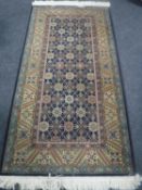 A Caucasian design rug on indigo ground,