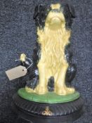A cast metal sheep dog door stop
