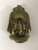 A Victorian brass door knocker in the form of Queen Victoria
