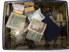 A tin of British pre-decimal coins and foreign coins, various banknotes including Peru, Canada,