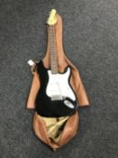 An Encore electric guitar in soft carry case