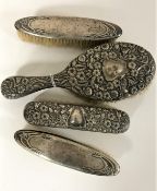 Four silver back dressing table brushes