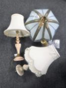 A pair of wooden table lamps with tasselled shades together with a brass and glass pendant light