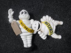 Two cast metal Michelin men money boxes