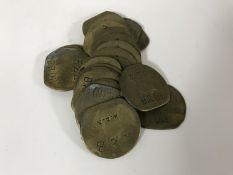 Twenty vintage brass railway pay check tokens.