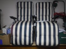 A pair of folding garden loungers