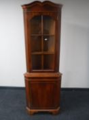 A yew wood corner display cabinet