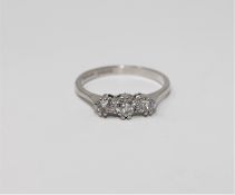 An 18ct white gold three stone diamond ring, approximately 1ct, size N.