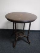 A circular inlaid mahogany lamp table