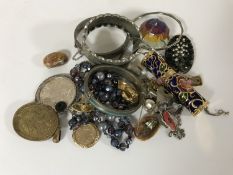 A collection of silver bangles, cuff bracelets, coin pendants,