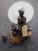 A contemporary Art Deco style table lamp on wooden base