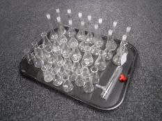 A tray of scientific glass beakers and test tubs