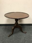 A George III mahogany tripod low table,