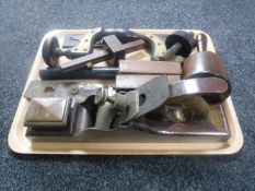 A tray containing antique woodworking tools