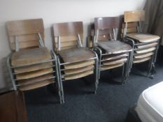 A set of eighteen mid 20th century tubular metal framed stacking school chairs