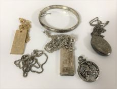 Two jubilee pendants, a silver bangle,