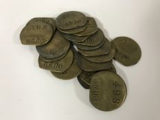 Twenty vintage brass railway pay check tokens.