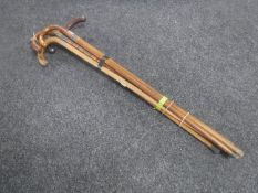 A bundle of seven antique and later walking sticks,