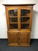An Edwardian oak double glazed door corner cabinet