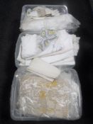 Three plastic crates of vintage table linen