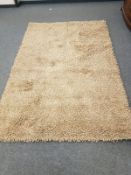 A hand knotted shaggy beige rug,