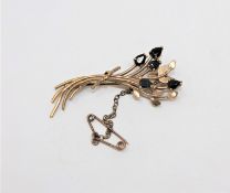 A 9ct gold sapphire set floral spray brooch CONDITION REPORT: 3.