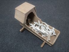 A miniature wooden doll's cot and a pair of wall candle sconces