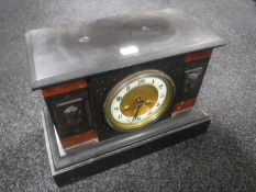 A Victorian black slate mantel clock with brass and enamelled dial