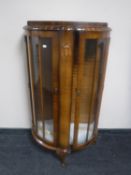 A 1930's walnut shaped display cabinet