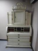 A continental cream and gilt cylinder bureau
