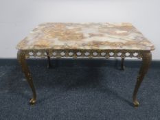 An onyx topped coffee table on a gilt metal base