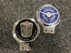 Two vintage car badges;