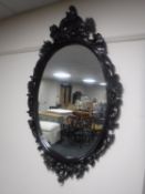 A wood framed Rococo style wall mirror