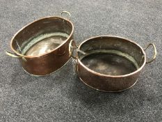 Two graduated antique copper brass handled pans