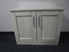 A pine effect double door cabinet