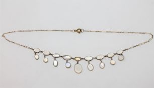 A moonstone necklace on yellow metal chain