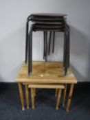 A nest of pine tables and five circular mid 20th century stools on metal legs
