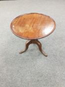 A George III mahogany tripod low table,