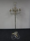 A brass eight way floor lamp with glass drops