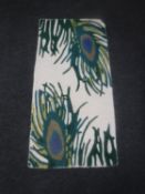 A woollen peacock design rug on ivory ground,